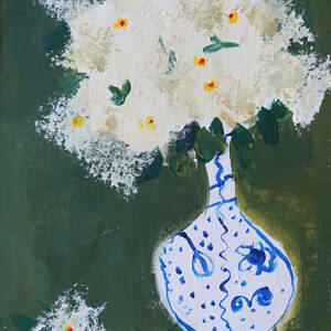 Blue and White vase containing white flowers on a green background