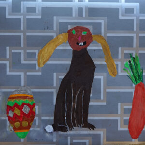 red and green easter egg, black bunny with yellow ears and an orange and green carrot on grey wallpaper